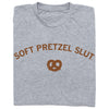 A heather grey t-shirt featuring the brown text SOFT PRETZEL SLUT above an icon of a pretzel.
