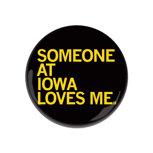 Round black RAYGUN pin-back button with yellow text that reads SOMEONE AT IOWA LOVES ME.
