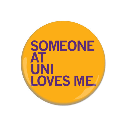 A round yellow RAYGUN pin-back button featuring the purple text SOMEONE AT UNI LOVES ME.