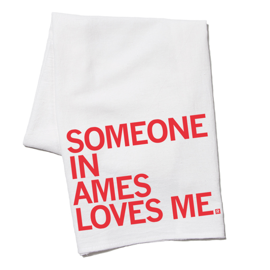 White kitchen towel with the red screen print SOMEONE IN AMES LOVES ME.