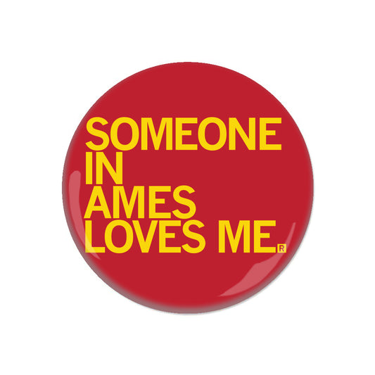 Red RAYGUN metal button with the yellow text SOMEONE IN AMES LOVES ME.