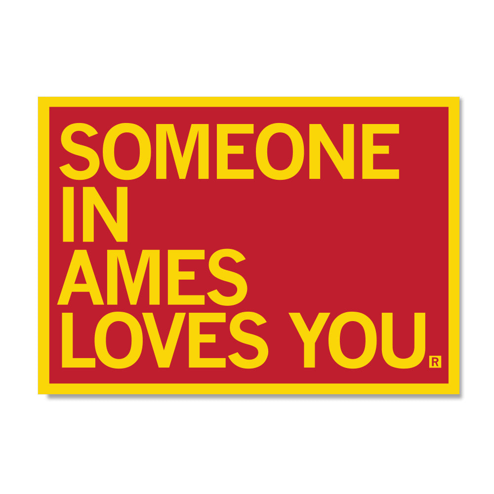 A red rectangular RAYGUN sign with a yellow border and the yellow text SOMEONE IN AMES LOVES YOU.