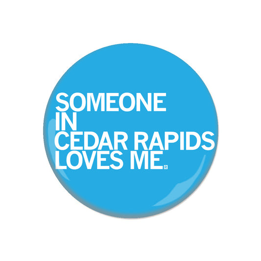 Blue RAYGUN circular button that says SOMEONE IN CEDAR RAPIDS LOVES ME.