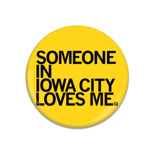 Yellow RAYGUN metal button pin that reads, SOMEONE IN IOWA CITY LOVES ME.