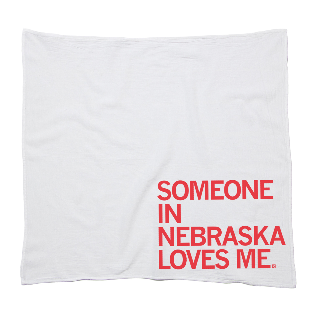 White flour sack towel with the red text SOMEONE IN NEBRASKA LOVES ME.