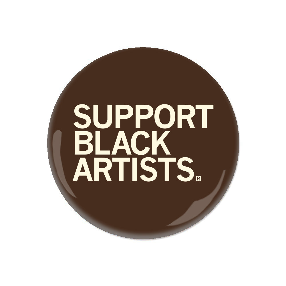 Brown RAYGUN circular pin button featuring the white text SUPPORT BLACK ARTISTS.