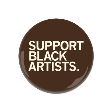 Brown RAYGUN circular pin button featuring the white text SUPPORT BLACK ARTISTS.