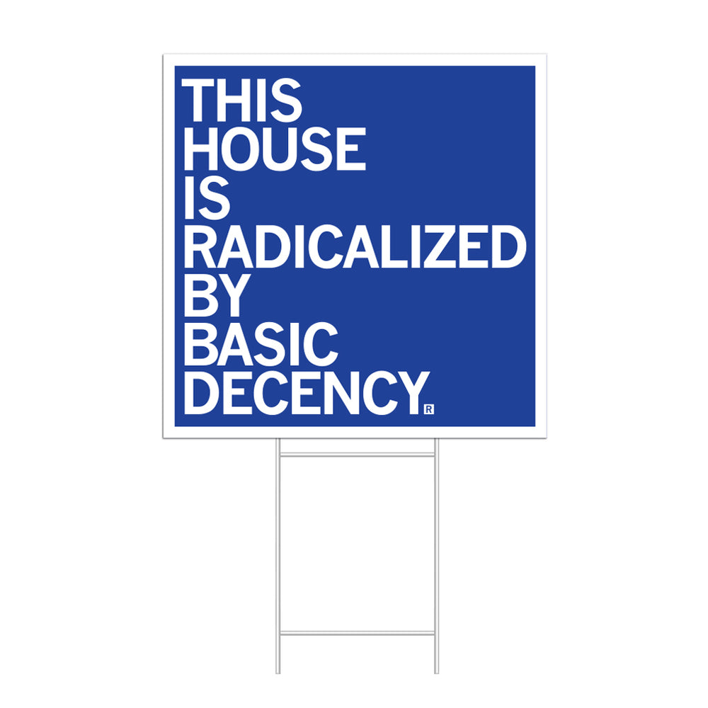 A square royal blue yard sign with a white border and white left-aligned text that reads "This house is radicalized by basic human decency"