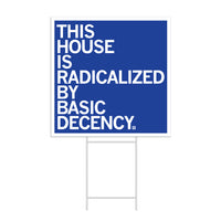 A square royal blue yard sign with a white border and white left-aligned text that reads "This house is radicalized by basic human decency"