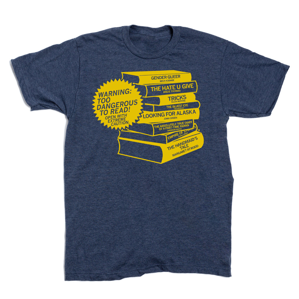 Dark heather denim t-shirt featuring a yellow graphic of a stack of dangerous books with a Warning: Too Dangerous to Read! starburst, listing titles such as Gender Queer, The Hate U Give, and The Handmaid’s Tale.