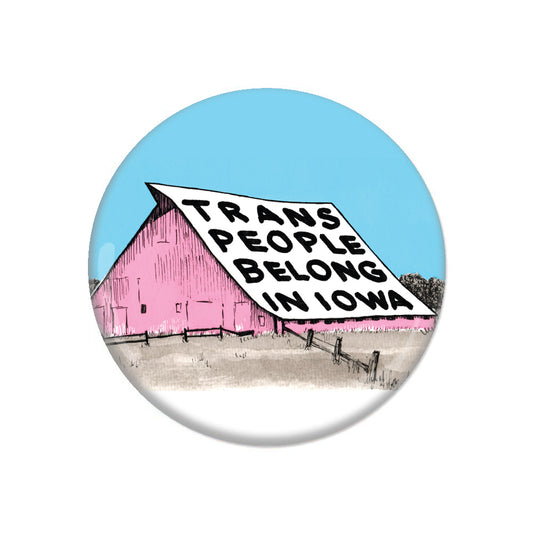 A pink barn with a sign on its roof reading, Trans People Belong In Iowa, in support of the Iowa Trans Mutual Aid Fund.