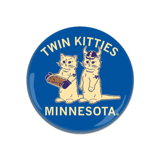 Blue circular button featuring two cats with the text TWIN KITTIES at the top and MINNESOTA at the bottom; one cat wears a Viking helmet and the other holds a casserole dish, a humorous nod to Minneapolis.