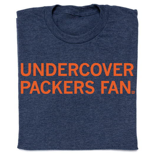 Dark blue RAYGUN T-shirt featuring the orange text UNDERCOVER PACKERS FAN.