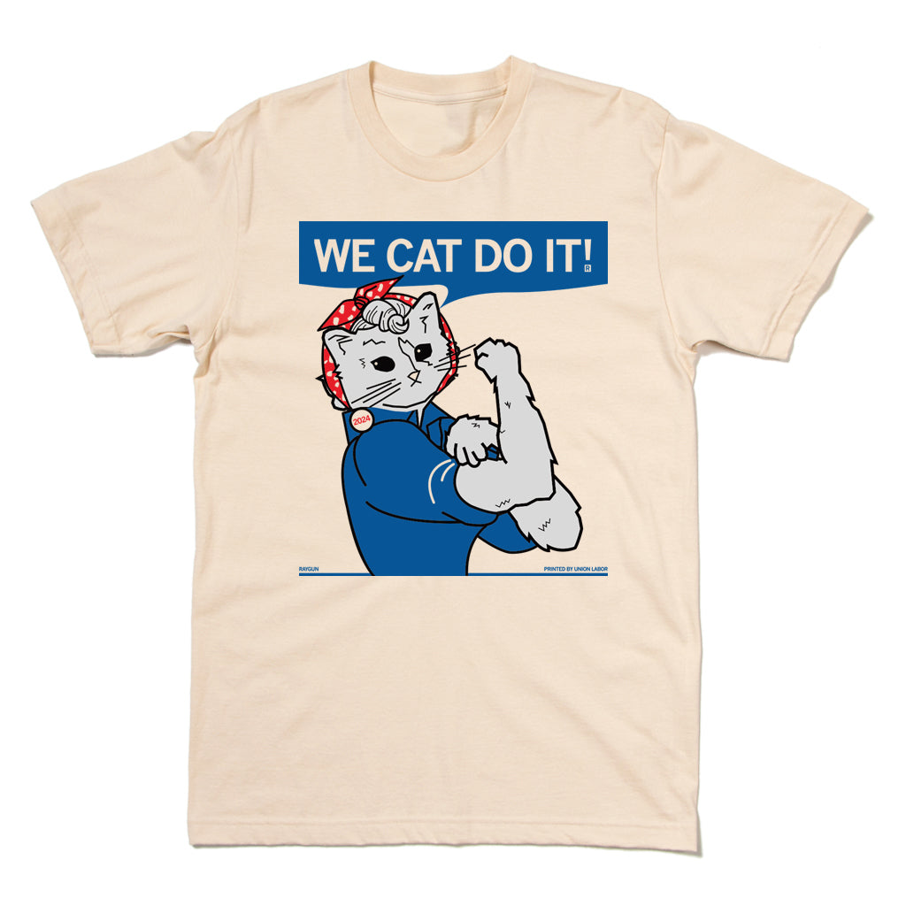 Cream ringspun cotton t-shirt featuring a cat wearing a red bandana and blue shirt, posing like Rosie the Riveter with the text WE CAT DO IT! above.