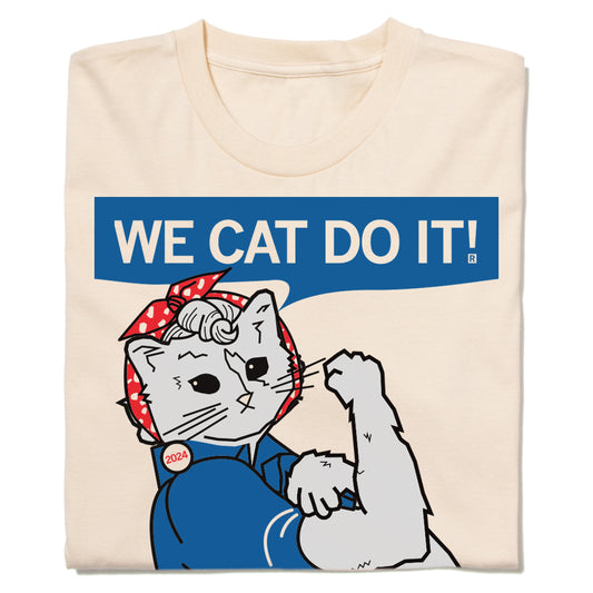 Cream-colored, union-made t-shirt featuring a cat dressed as Rosie the Riveter with a speech bubble that reads, WE CAT DO IT!.