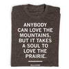 Dark grey union made t-shirt featuring the Willa Cather quote: Anybody can love the mountains, but it takes a soul to love the prairie.