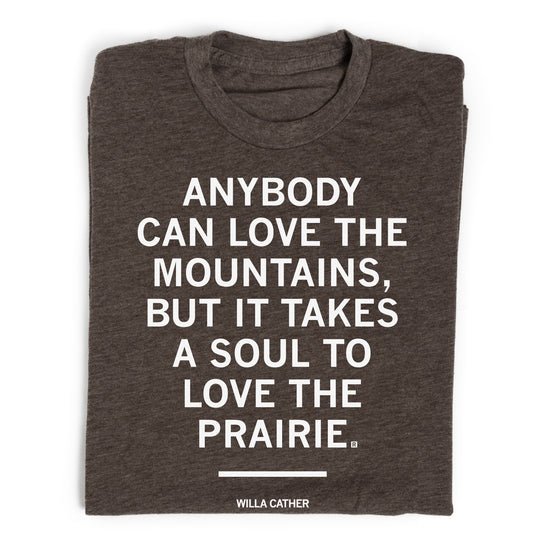 Dark grey union made t-shirt featuring the Willa Cather quote: Anybody can love the mountains, but it takes a soul to love the prairie.