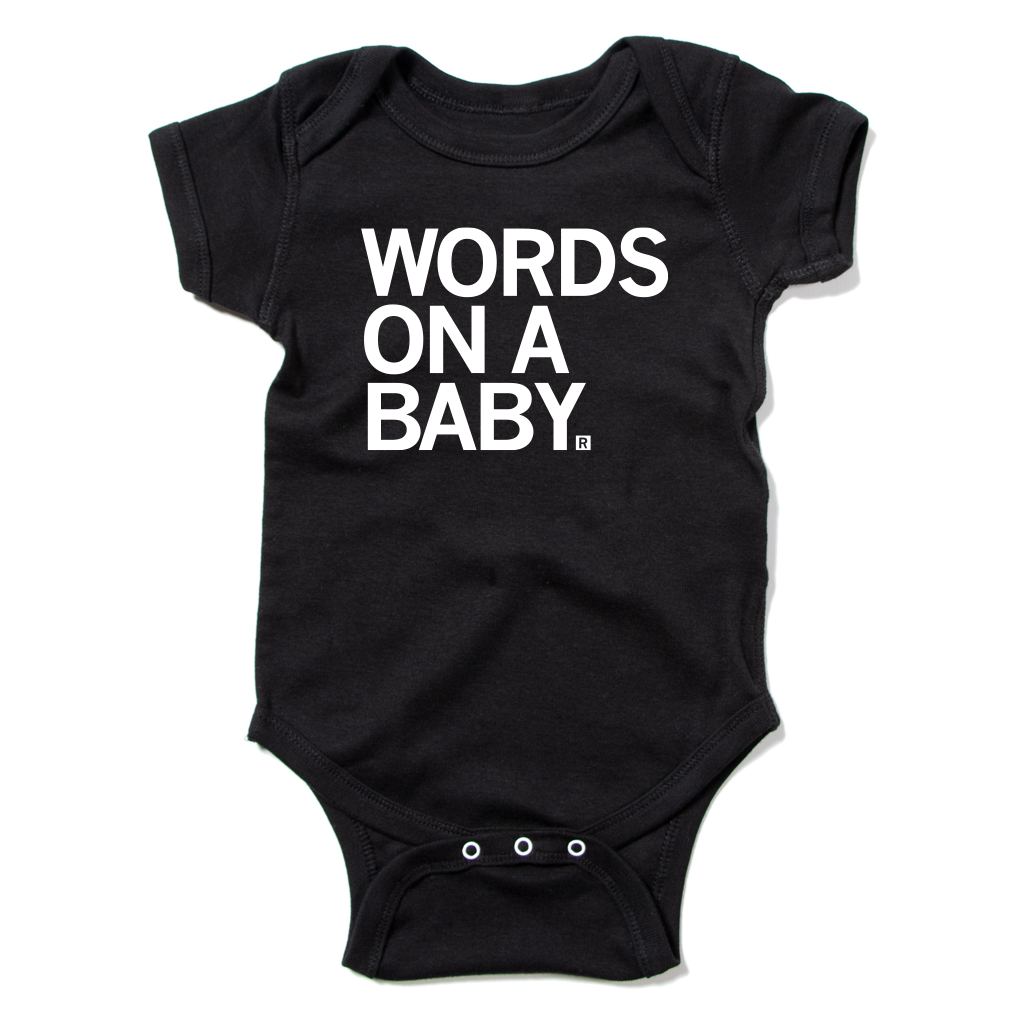 Black baby onesie with the text WORDS ON A BABY printed in white on the chest.