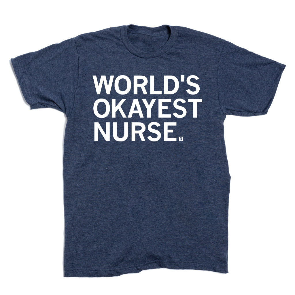 Navy blue RAYGUN t-shirt featuring the white text WORLDS OKAYEST NURSE printed on the chest.
