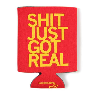 Red foam can cooler with yellow RAYGUN text reading SHIT JUST GOT REAL and a small website URL at the base.
