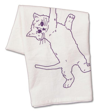 White flour sack kitchen towel featuring a purple line drawing of a cat hanging by one paw.