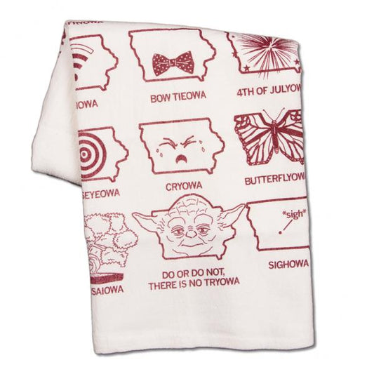 A white flour sack towel printed with a grid of Iowa-themed puns and illustrations, including Bow Tieowa, Cryowa, and a Yoda-themed Do or do not, there is no Tryowa.