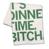 White flour sack kitchen towel with the green screen printed text, It’s dinnertime, bitch.