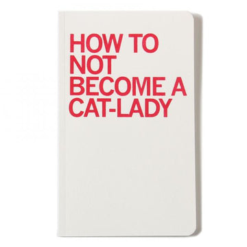 White screen-printed notebook with the red text HOW TO NOT BECOME A CAT-LADY on the cover.