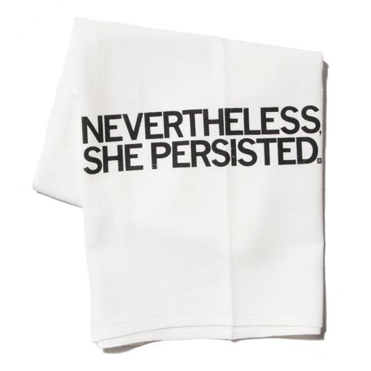 White folded flour sack towel printed with the black text NEVERTHELESS, SHE PERSISTED.