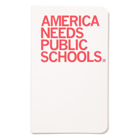 A white, union-made notebook with the red text AMERICA NEEDS PUBLIC SCHOOLS printed on the cover.