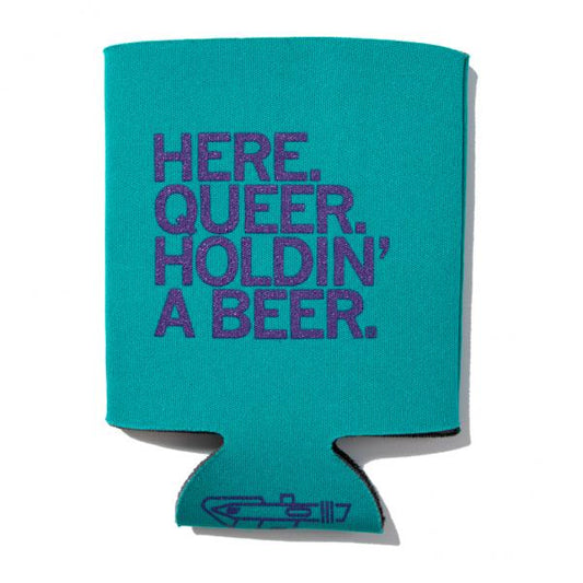 Teal fade-resistant foam can cooler with the purple text HERE. QUEER. HOLDIN A BEER.
