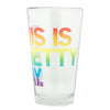 Clear, dishwasher-safe drinking glass with a rainbow-gradient print that reads THIS IS PRETTY GAY.