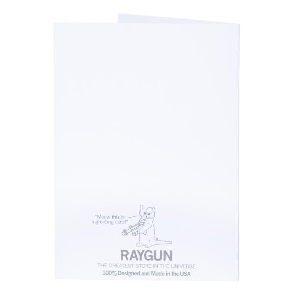 A white greeting card featuring a cat holding a ray gun, the text Meow this is a greeting card!, the Raygun logo, and the phrase THE GREATEST STORE IN THE UNIVERSE. This blank inside folded greeting card is made in the USA.