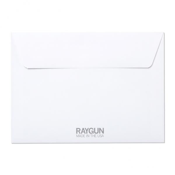A plain white folded greeting card envelope with the text RAYGUN MADE IN THE USA printed in gray at the bottom.