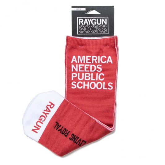 Red crew socks made in the USA with AMERICA NEEDS PUBLIC SCHOOLS printed in white on the leg and RAYGUN on the white toe.