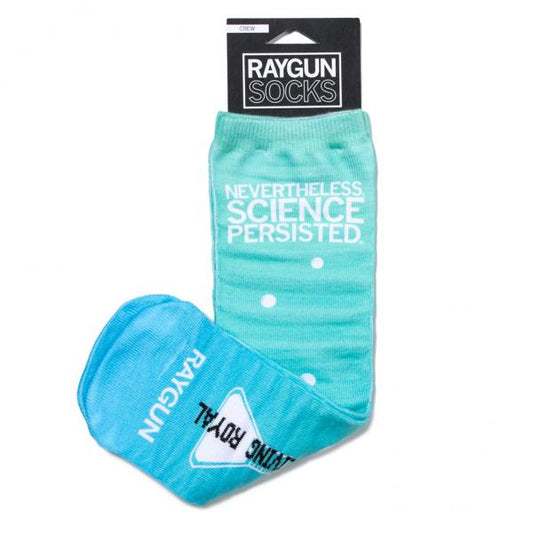 Light blue, handmade crew socks with the text NEVERTHELESS, SCIENCE PERSISTED and white dots, hanging on a branded Raygun card.