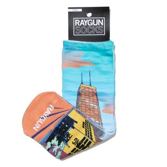 Raygun crew socks featuring a graphic of the Chicago skyline and a sunset on a white background, perfect as a Chicago souvenir.
