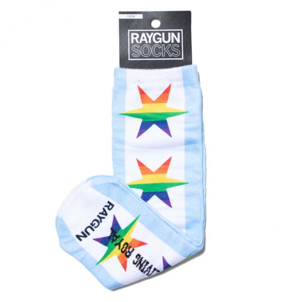 Light blue crew socks with a vertical pattern of rainbow-colored stars and the text LIVING ROYAL and RAYGUN printed on the foot, perfect for Chicago pride.