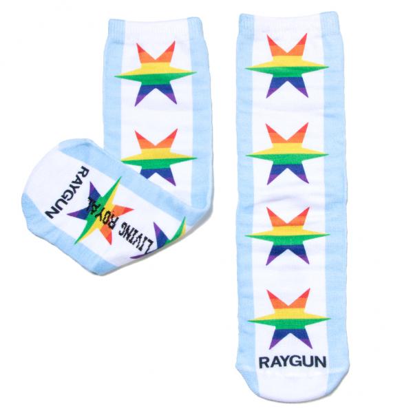 A pair of handmade white crew socks with light blue stripes and rainbow-colored stars, featuring the text RAYGUN on the toes.