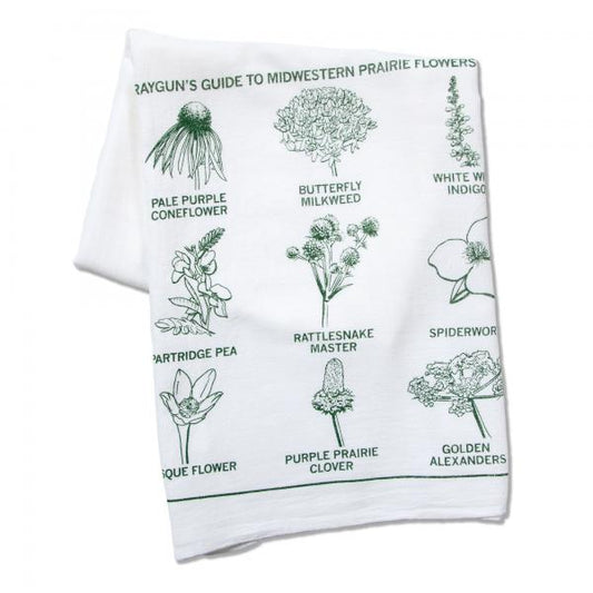 A white kitchen towel featuring a green illustration titled Rayguns Guide to Midwestern Prairie Flowers, with labeled drawings of various native wildflowers.