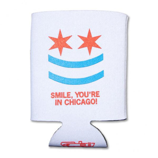 White scuba foam can cooler featuring a smiley face made of two red stars and two blue stripes, with the text SMILE, YOURE IN CHICAGO! below it.