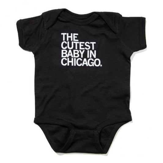 Black baby rib cotton infant bodysuit with white text that reads, THE CUTEST BABY IN CHICAGO.