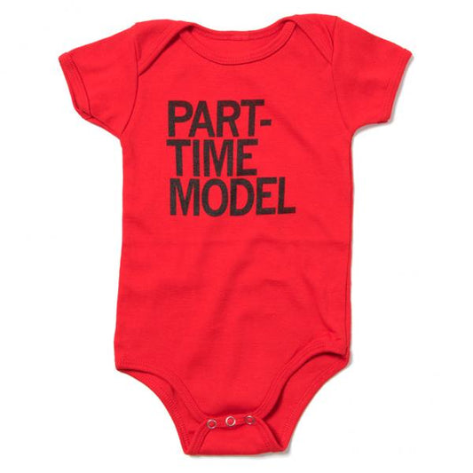 Red short-sleeved union made baby onesie with the text PART-TIME MODEL in black screen print.