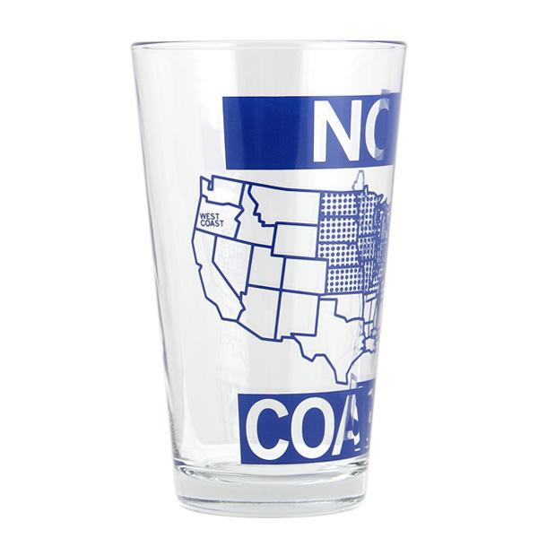 Clear dishwasher-safe pint glass featuring a blue outline map of the United States with the words WEST COAST printed in soy-based ink across the left side.