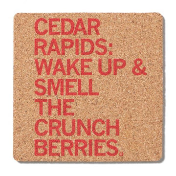 Square cork coaster featuring red text that reads, CEDAR RAPIDS: WAKE UP & SMELL THE CRUNCH BERRIES.
