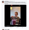 A woman in a Pigment Black Pullover Hoodie speaks to the camera while stirring a large pitcher of purple smoothie.