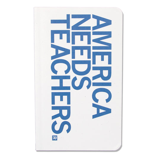 A white, union-labor-made notebook with blue text that reads, AMERICA NEEDS TEACHERS.