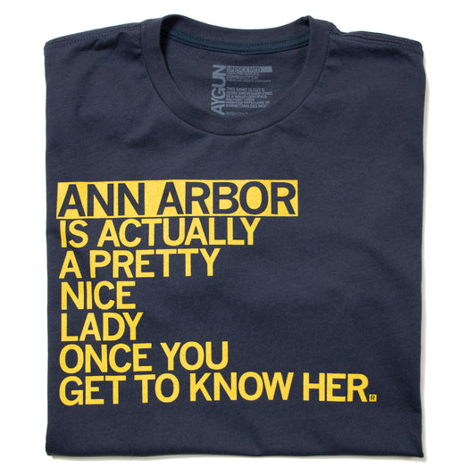 A union made navy blue T-shirt featuring the yellow text, Ann Arbor is actually a pretty nice lady once you get to know her.