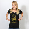 A smiling woman wearing a union made black t-shirt featuring a gold graphic of children around a basket and the text NEVER FORGET.