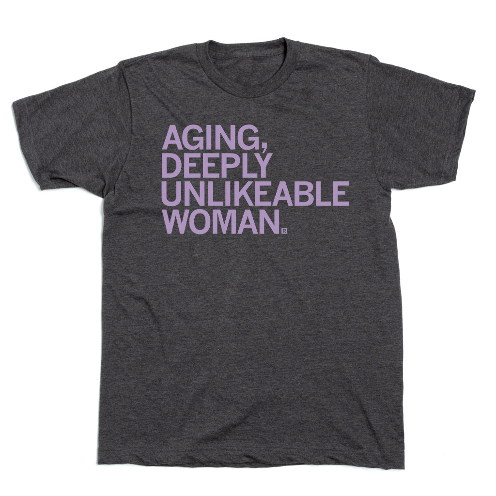 Charcoal t-shirt with the lilac screen print AGING, DEEPLY UNLIKEABLE WOMAN. across the chest.